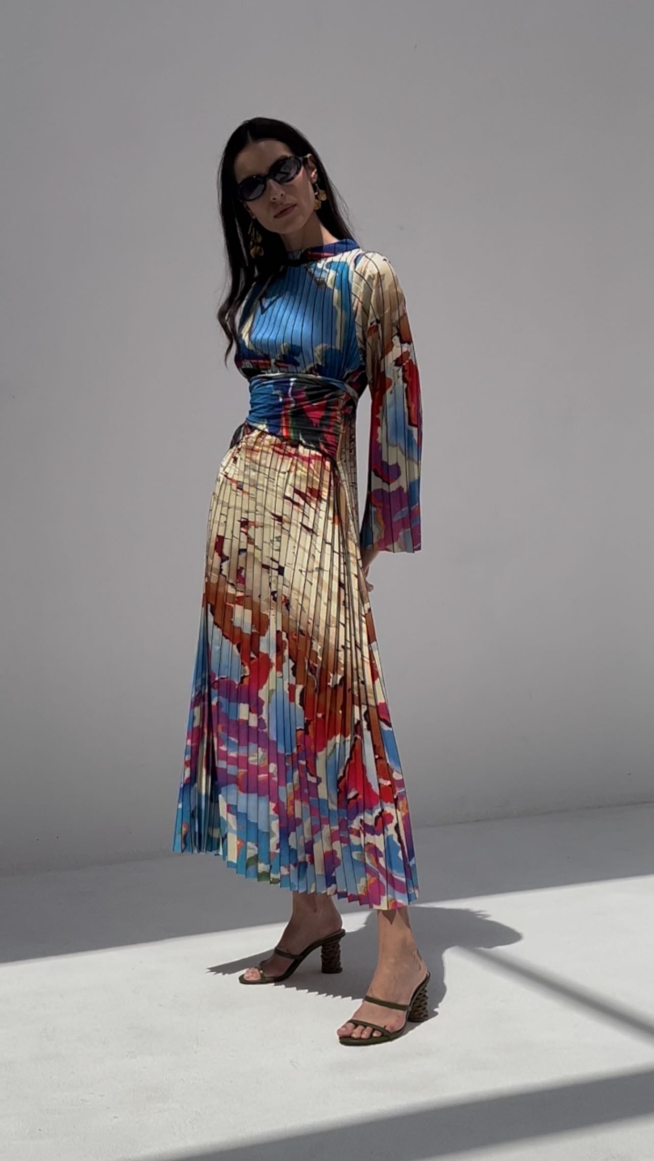 Effortlessly graceful and subtly bold in Grace Pleated Dress.