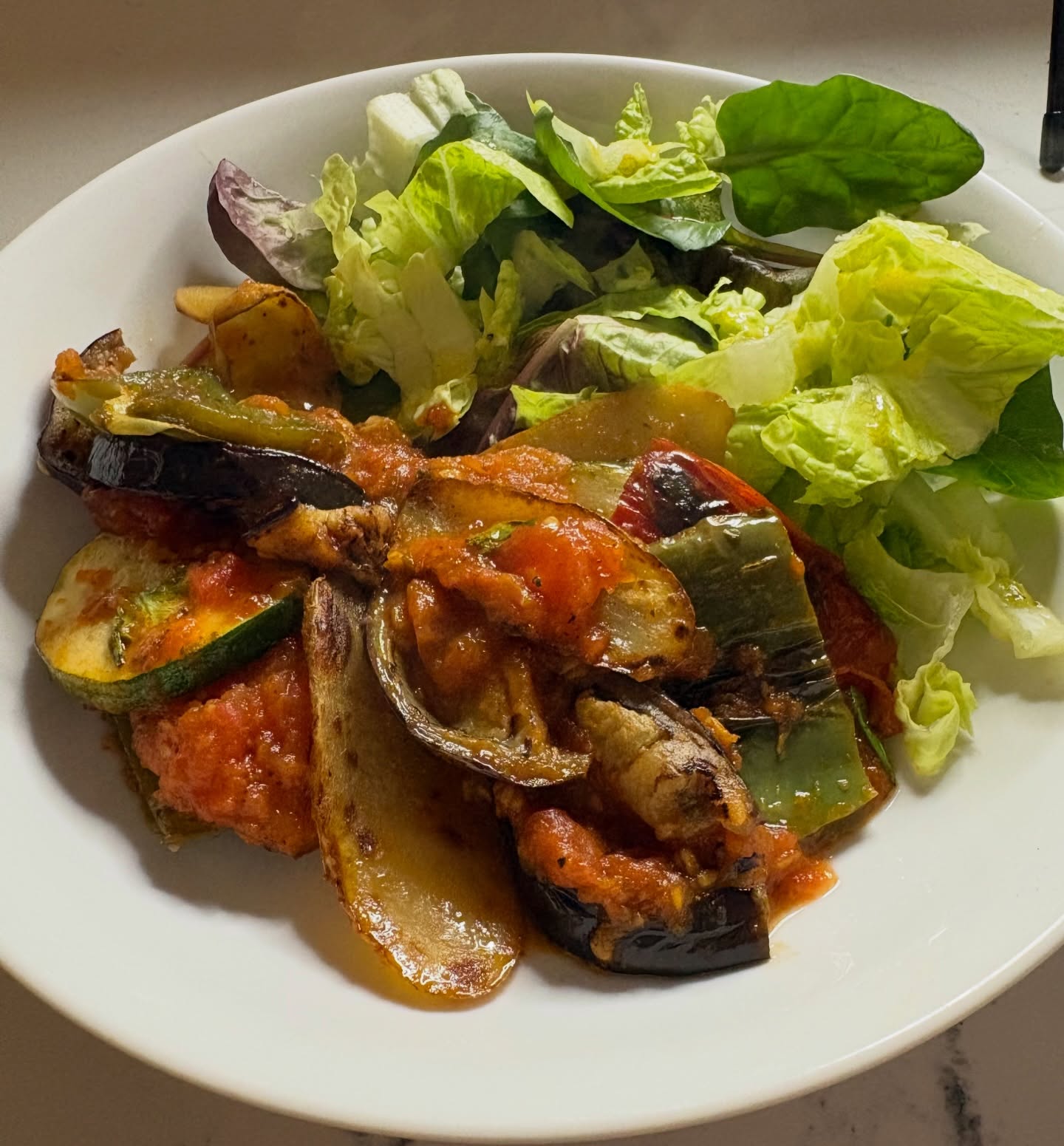 In my ongoing quest to eat more healthily, I made Mallorcan Tumbet for dinner, as I’d had it at the wonderful Es Moli restaurant in Santanyi and had always wanted to recreate it. However, I hadn’t realised that it would be a labour of love, and that it would actually have been quicker to fly to Mallorca for dinner…(hence the choice of accompanying music!)
Anyway, it’s a delicious dish of aubergines, red and green peppers, courgettes and potatoes sautéed in olive oil and then layered individually with a fresh tomato sauce and herbs. It’s often served at room temperature as a round layered dish but I served it hot in a large dish - not as pretty but just as tasty ?
#mallorca #spanishfood #healthyeating