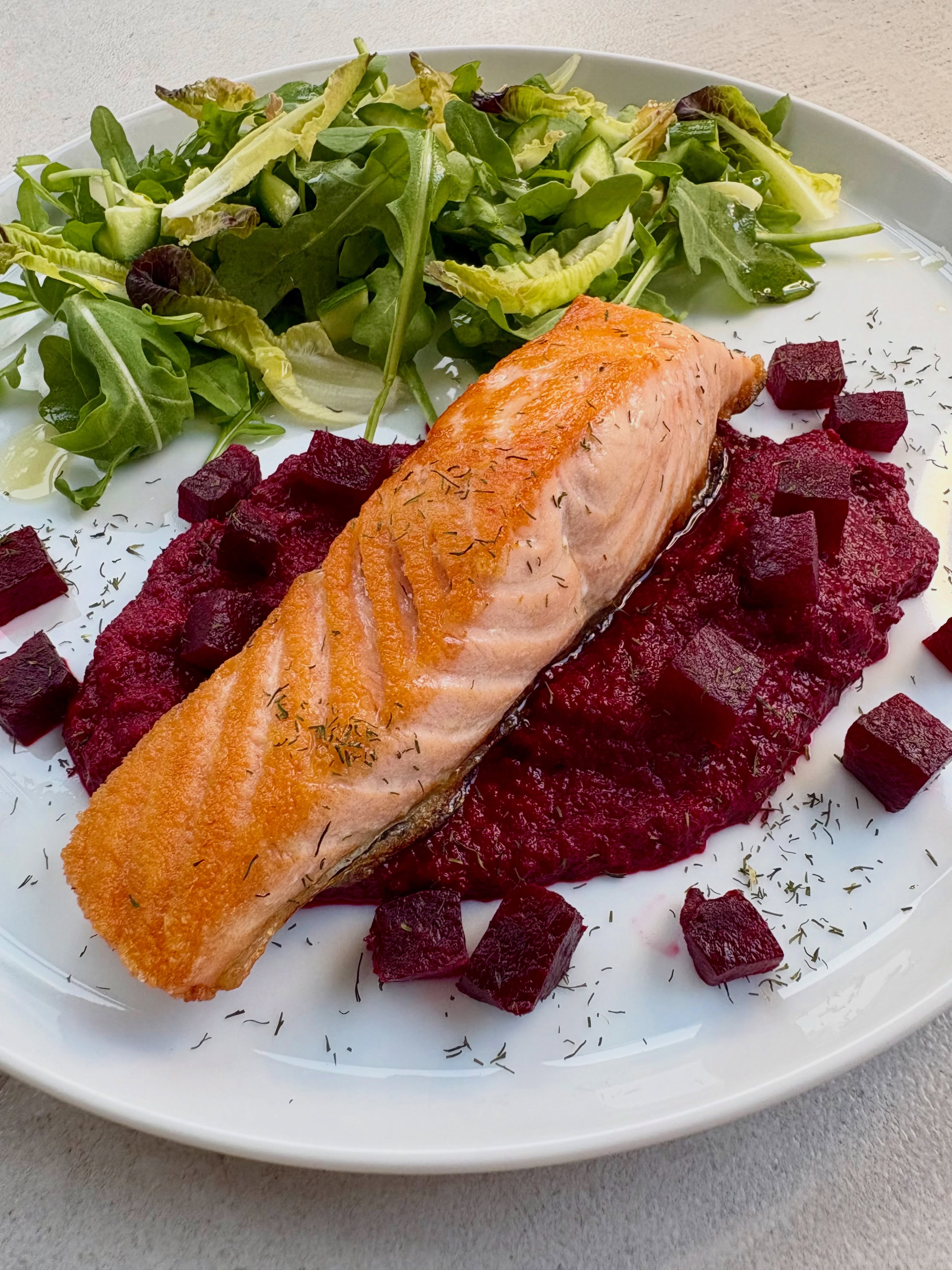 I love beetroot (and yes, I do say that about most things!) and I love it with salmon in a salad so why not hot? Roasted some beetroot in foil then made a puree (should have sieved it) with a touch of garlic, red wine vinegar and some Greek yoghurt and seasoning. Wasn’t perfect but still tasty and so nice with the pan fried salmon. Tried to be a bit fancy so scattered over some small beetroot cubes and some freeze dried dill, as I was out of fresh. Will make again ?
#salmon #beetroot #healthyeating